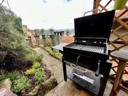 a barbecue grill sitting on top of a patio at VILLA Como, Jacuzzi Spa and Private Pool in Blevio