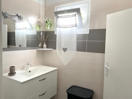 a bathroom with a white sink and a mirror at Maison de 2 chambres avec jardin clos et wifi a Saint Pierre d'Oleron a 1 km de la plage in Saint-Pierre-dʼOléron