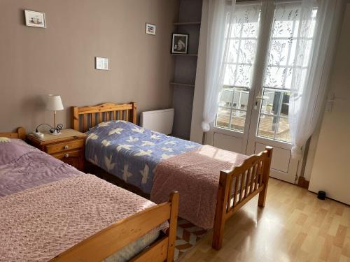 a bedroom with two beds and a window at Maison de 2 chambres avec jardin clos et wifi a Saint Pierre d'Oleron a 1 km de la plage in Saint-Pierre-dʼOléron