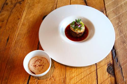 a plate of food and a cup of coffee on a table at LAGO hotel & restaurant am see in Ulm