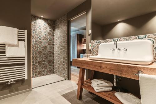 a bathroom with a sink and a walk in shower at Hosler in Merano