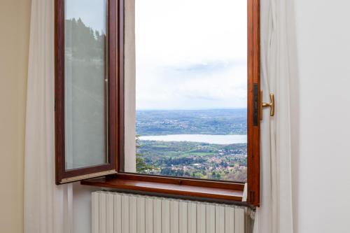 an open window with a view of a city at Albergo Sacro Monte Varese in Varese