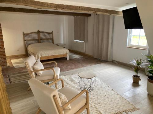 a living room with a bed and a table and chairs at Gite de l'épine in Haute-Épine