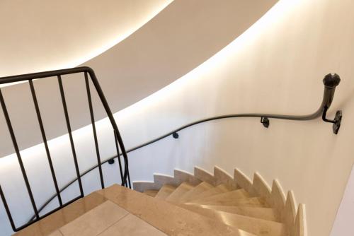 a staircase with a metal handrail and a stair case at Le Monachelle Luxury in Eboli