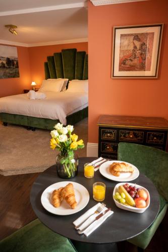 a hotel room with a table with food on it at The Fanny Talbot in Barmouth