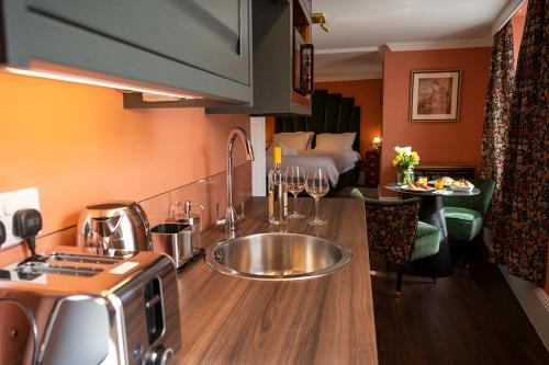 a kitchen with a sink and a bed in a room at The Fanny Talbot in Barmouth