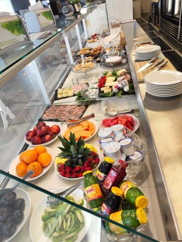 a buffet line with many different fruits and vegetables at Tabù Hotel in Porto Cesareo