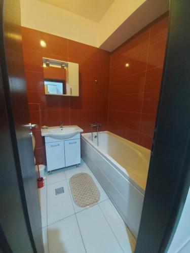 a bathroom with a tub and a sink at Bya Concept in Iaşi