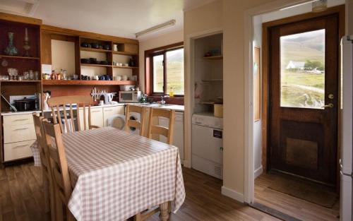 a kitchen with a table with a table cloth on it at Allt Slapin in Torrin