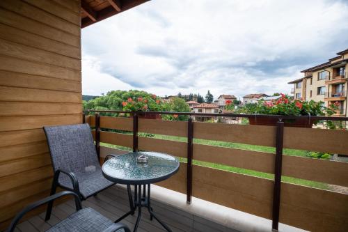 a table and chairs on a balcony with a view at Villa Pino in Velingrad