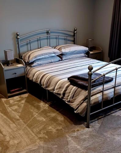 a bed with a metal frame in a bedroom at Large double room with spacious ensuite in Southbourne