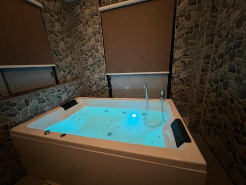 a bathroom with a bath tub with a shower at Hotel Kesu Home in Kathmandu