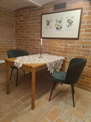 a table with two chairs and a candle on it at Kosbor Panzió in Magyarszombatfa