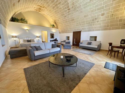 a living room with a couch and a table at Masseria Torre Spagnola in Matera