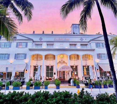 a building with palm trees in front of it at The Betsy Hotel, South Beach in Miami Beach