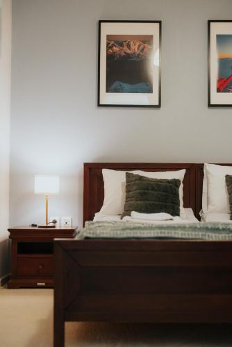 a bedroom with a bed and a table with a lamp at 1909 Guesthouse in Kalavrita