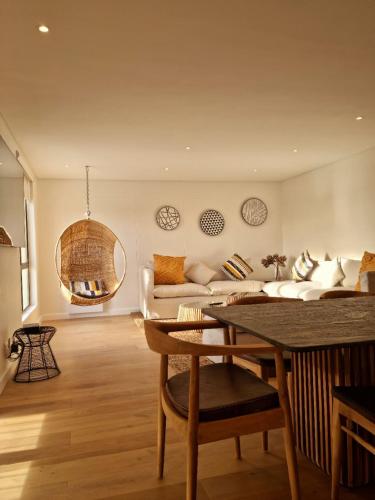a living room with a couch and a table at Island Club by Smart City Stays in Cape Town