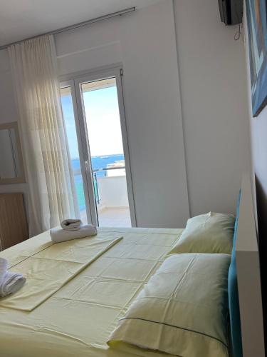 a bedroom with a bed with a view of the ocean at The Blue Horizon in Vlorë
