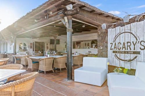 a restaurant with tables and chairs on a patio at Wyndham Residences Golf del Sur in San Miguel de Abona