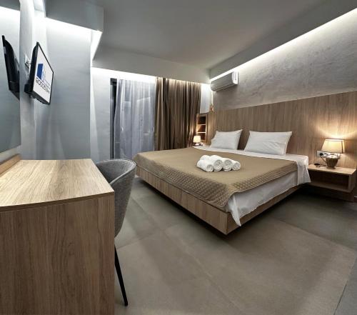 a hotel room with a bed and a desk at Rodosrooms in Rhodes Town
