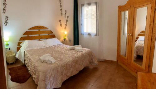 a bedroom with a bed with towels on it at Noemi Holiday House in Agnone Bagni