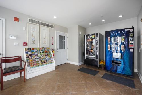 a store with a soda machine and a chair in a room at AquaVista Beach Resort by Panhandle Getaways in Panama City Beach