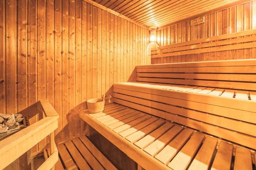 a wooden sauna with a wooden bench in it at Komló Hotel Gyula in Gyula