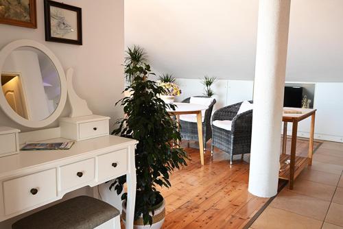 a living room with a table and a mirror at Tanya-Apartments and Rooms in Hvar