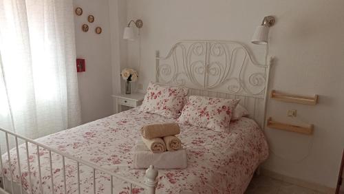 a bedroom with a bed with two teddy bears on it at Casa Liébana in Torrox