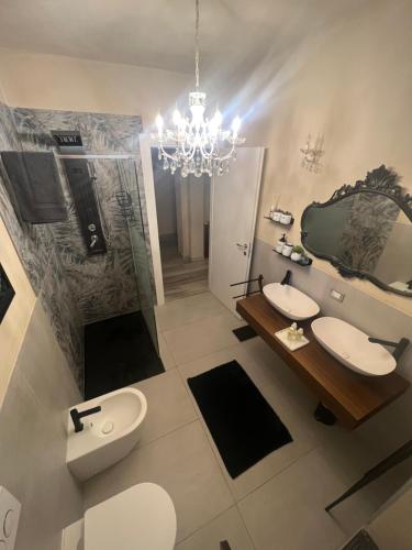 a bathroom with two sinks and a chandelier at Casa Vacanza Ginevra in Genoa