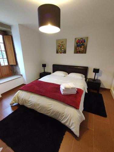 a bedroom with a large bed with two towels on it at Casa da Laranjeira in Barbeitos