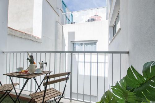 a balcony with a table and chairs on a building at Flatsforyou Carmen in Valencia