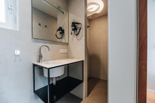 a bathroom with a sink and a mirror at Hotel - B&B Renesse in Renesse