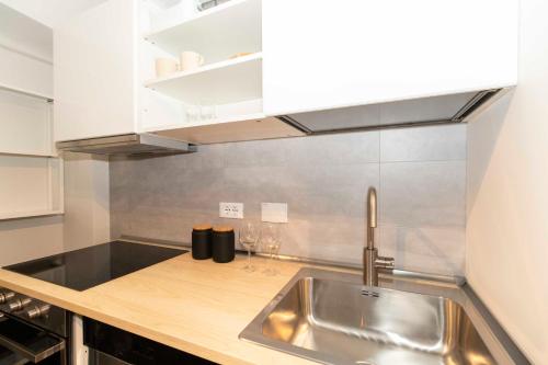 a kitchen with a sink and a counter top at La Mole Central & Comfy Apartment in Turin