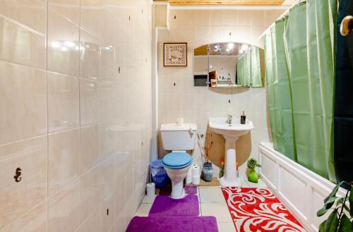 a bathroom with a toilet and a sink at House 220 in London