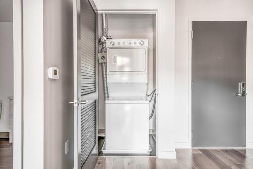 an empty kitchen with a refrigerator and a door at San Mateo 1br w pool gym wd nr Caltrain SFO-1237 in San Mateo