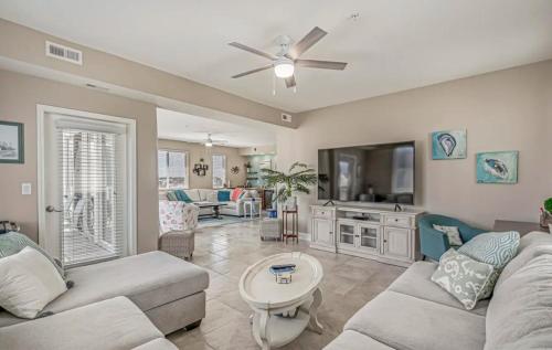 a living room with a couch and a table at Stunning Ocean Breeze Luxury Villas 4D-Across The Street From The Ocean! Sleeps 10 guests! in Myrtle Beach