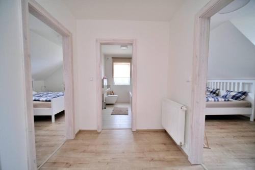 Habitación con 2 camas y pasillo con espejo. en Útulný horský apartmán v Jizerských horách, en Bedřichov