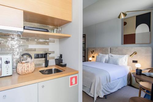 a hotel room with a bed and a sink at Regras 45 Building B by LovelyStay in Porto