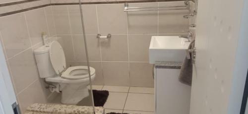 a bathroom with a toilet and a sink at Jordy 1 your home away from home in Margate