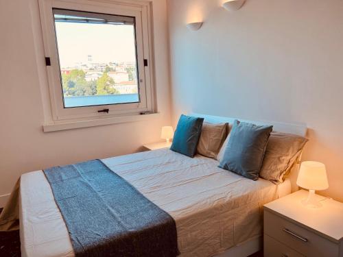 a bedroom with a bed with a window at The Sky of Cagliari in Cagliari
