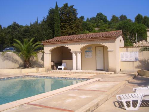 a house with a swimming pool and a building at APPART'18 - DOMAINE DE LA SOURCE in Uzès