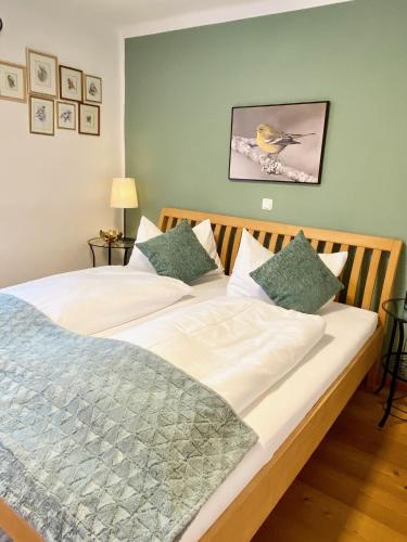 a bedroom with a large bed with a bird on it at Burgi Kefer in Bad Ischl