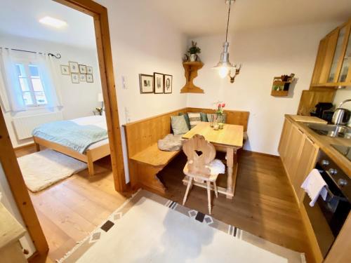 a kitchen and living room with a table and a bed at Burgi Kefer in Bad Ischl