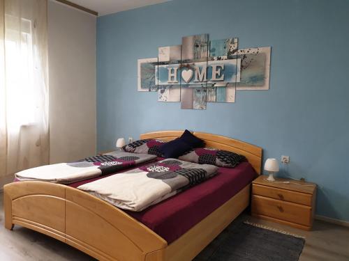 a bedroom with a bed with a wooden frame at Appartement Drava 1 in Donja Dubrava