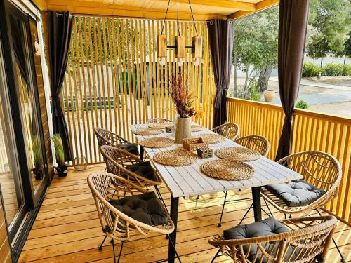 a white table and chairs on a deck at Brand New Mobile House - Soline Beach in Biograd na Moru