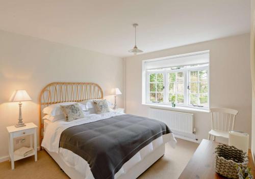 a bedroom with a large bed and a window at Chantry Place in Long Melford