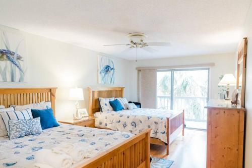 a bedroom with two beds and a window at Lagoon Villa 25 - Heart of Wild Dunes, Quick Walk to Beach in Isle of Palms