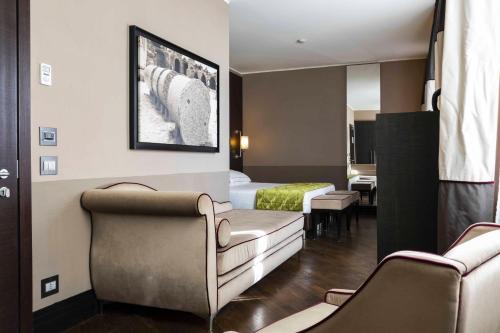 a hotel room with a bed and a couch and chairs at Rome Times Hotel in Rome