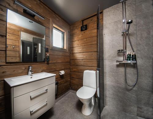 a bathroom with a shower and a toilet and a sink at Laxhall Hotell Krog Konferens in Torsö